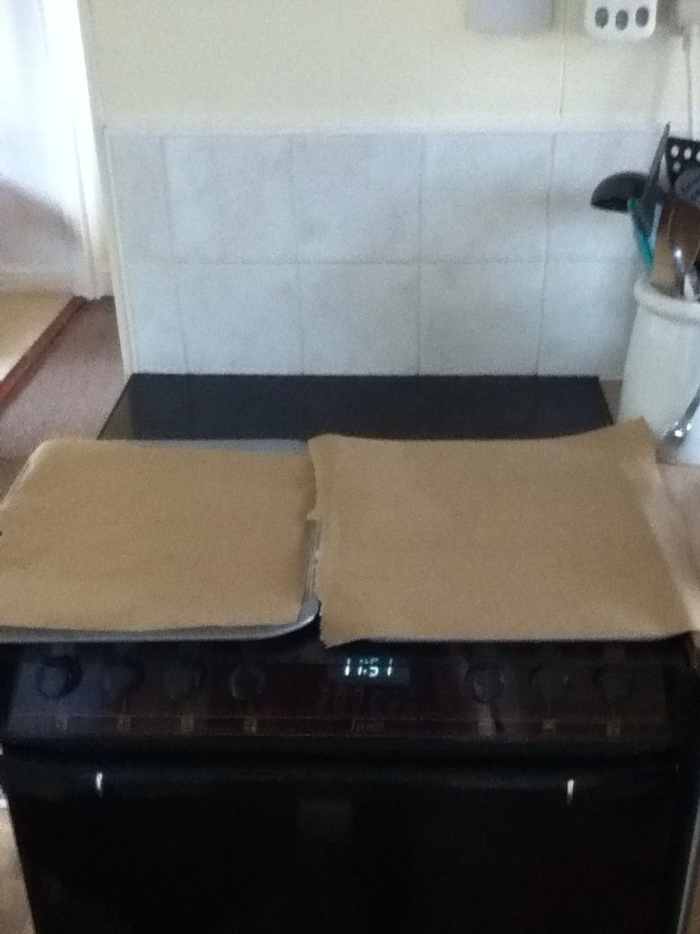 Place the grease proof paper onto the baking trays