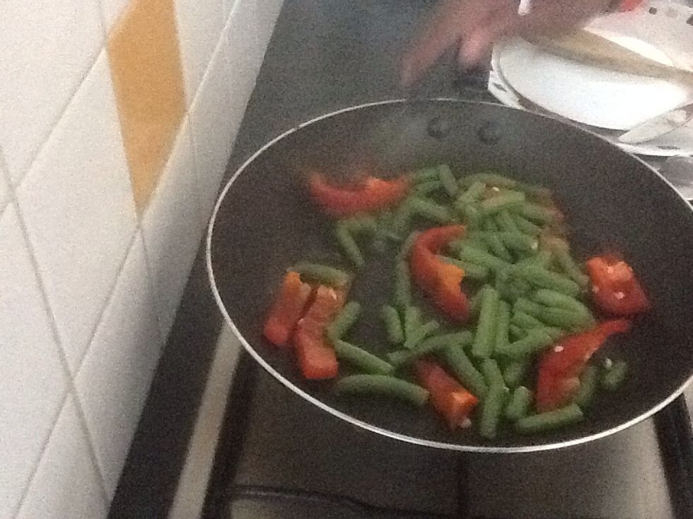 Place the green beans onto the pan and stir fry until brown.