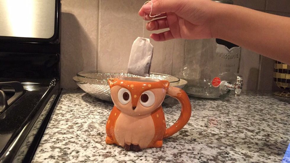 Place the green tea bag in the hot water and wait for five minutes to get a strong taste