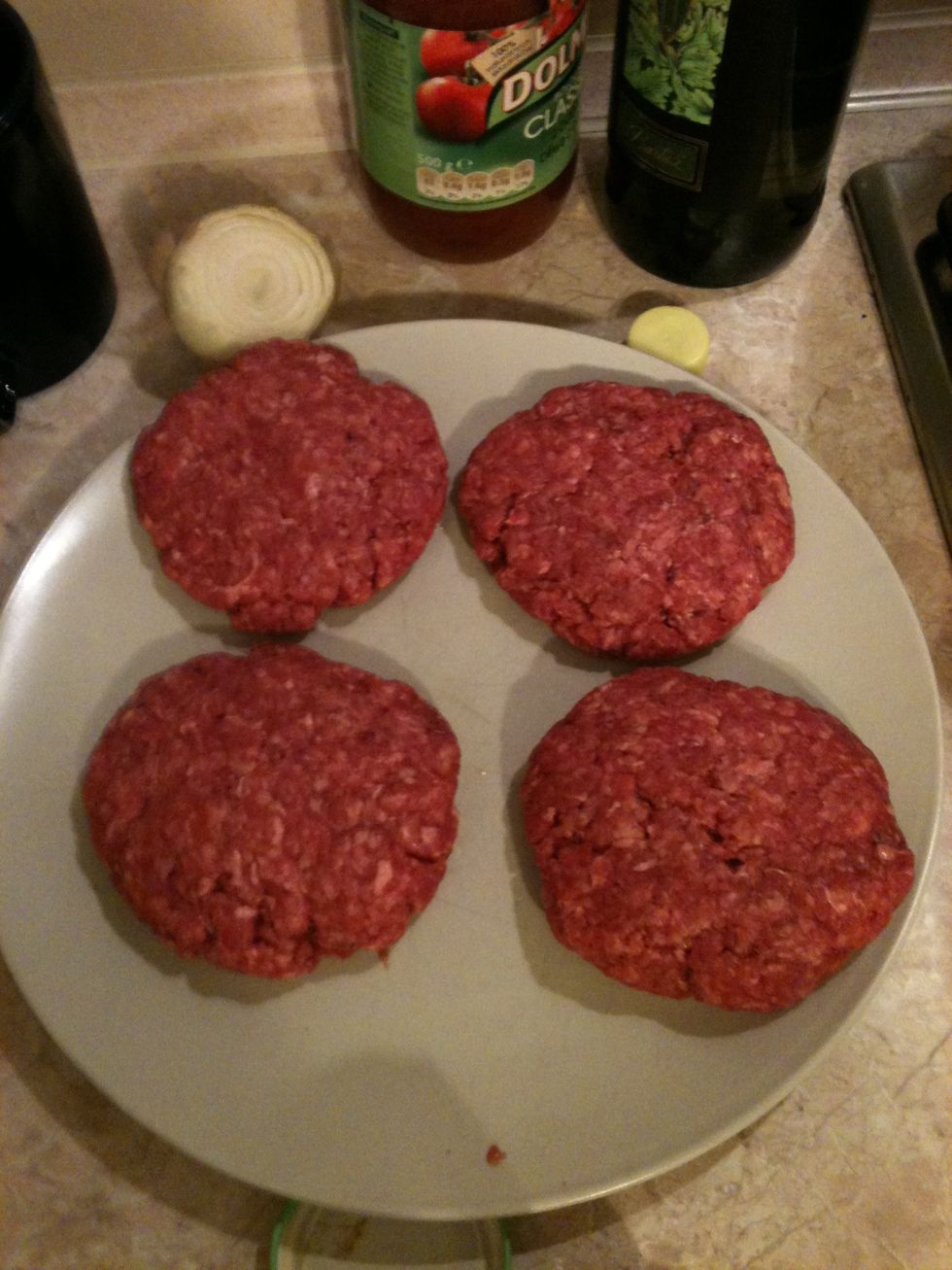 Place the ground beef in a big bowl. Add salt and pepper and mix it with your hands or fork. Then form into 4 patties approximately 3/4 inch thick.