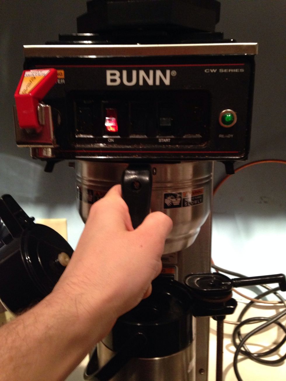 Place the ground coffee into the coffee machine.