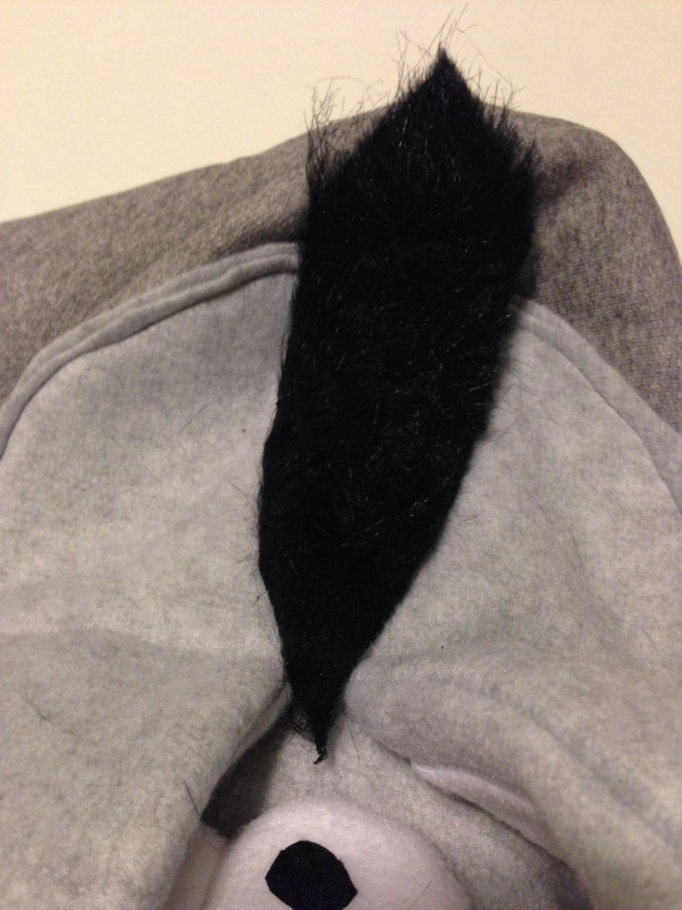 Place the hair down the way u want. I made the tip pointy so it can fall over to the eyes a bit. Glue down :)
