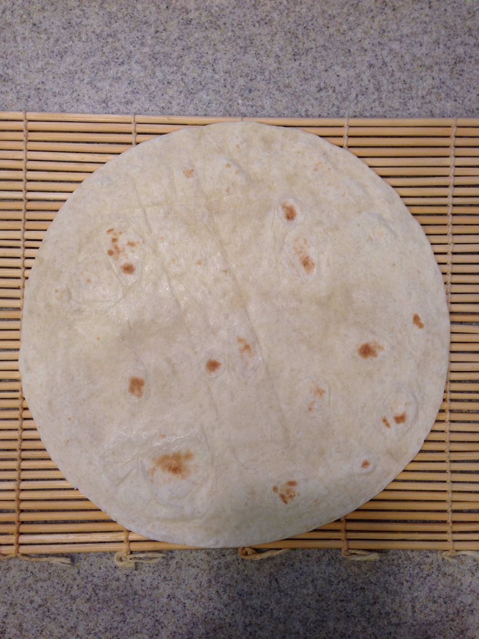 Place the heated tortilla on a sushi roller thing-a-ma-bob.