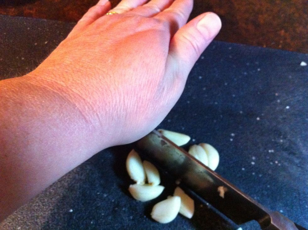 Place the heel of one hand on top of knife, the other on handle..moving handle up and down, leaving the tip of blade on the board.
