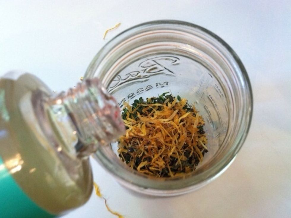 Place the herbs in a clean, sterilized glass container, like a mason jar. Next, pour the castor oil and hempseed oil over the herbs. Cover the jar with its lid and shake well to mix.