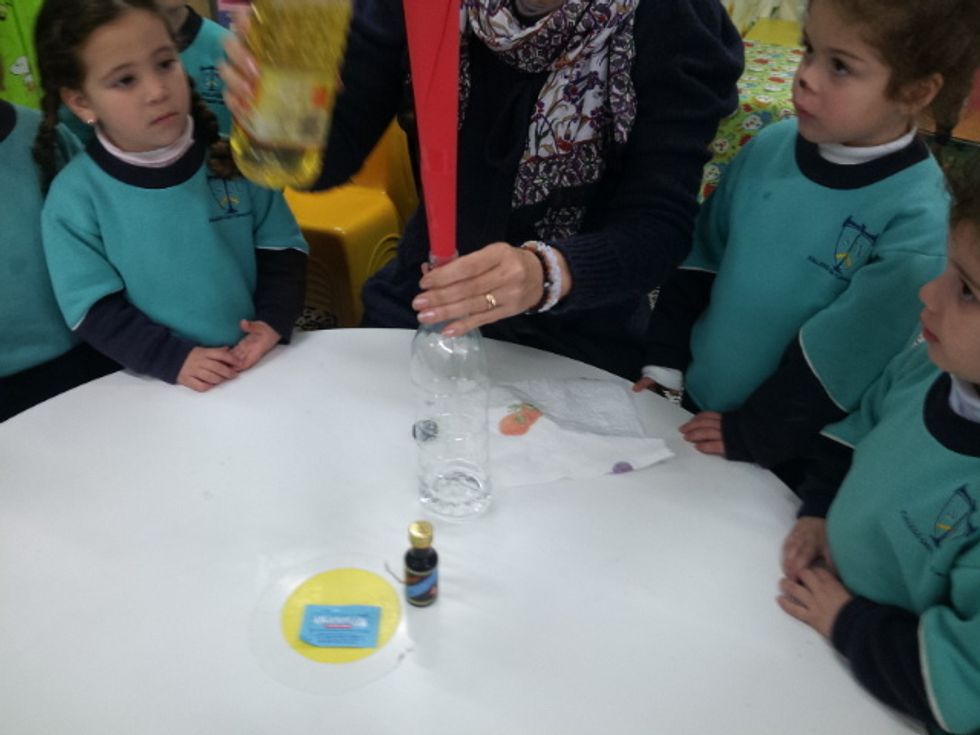 Place the home made funnel into the bottle and pour in the water