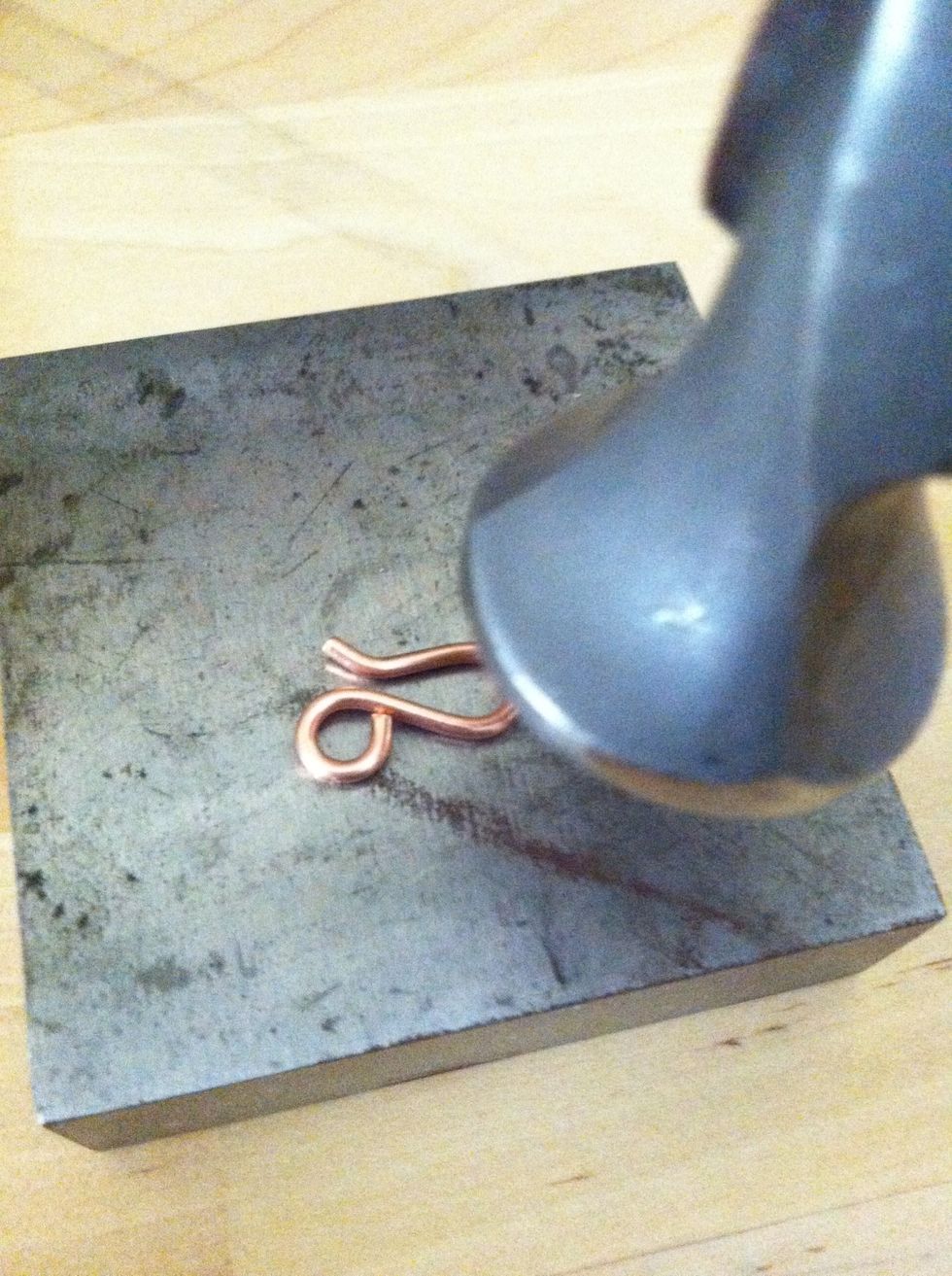 Place the hook on the bench block and lightly tap the curve of the hook, the curve of the loop and tip of the hook. Repeat for the eye taping the bottom of each loop.