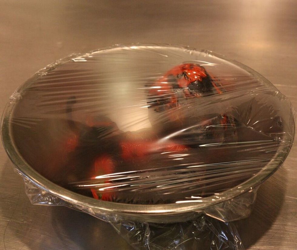 Place the hot peppers in a bowl, and cover with plastic wrap. Place the bowl in a warm spot for about twenty minutes. The peppers will \u201csweat\u201d, and the skin will naturally separate from the flesh.