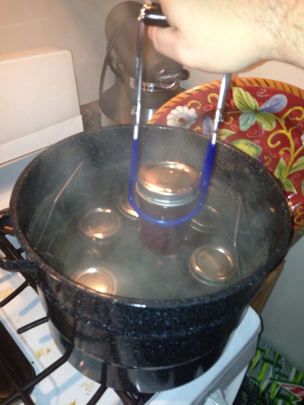 Place the jars CAREFULLY back into the boiling water. Let the process for 15 minutes, remove and place on a towel to cool. Check the deal by pressing on the top. If it pops, put it in the fridge.