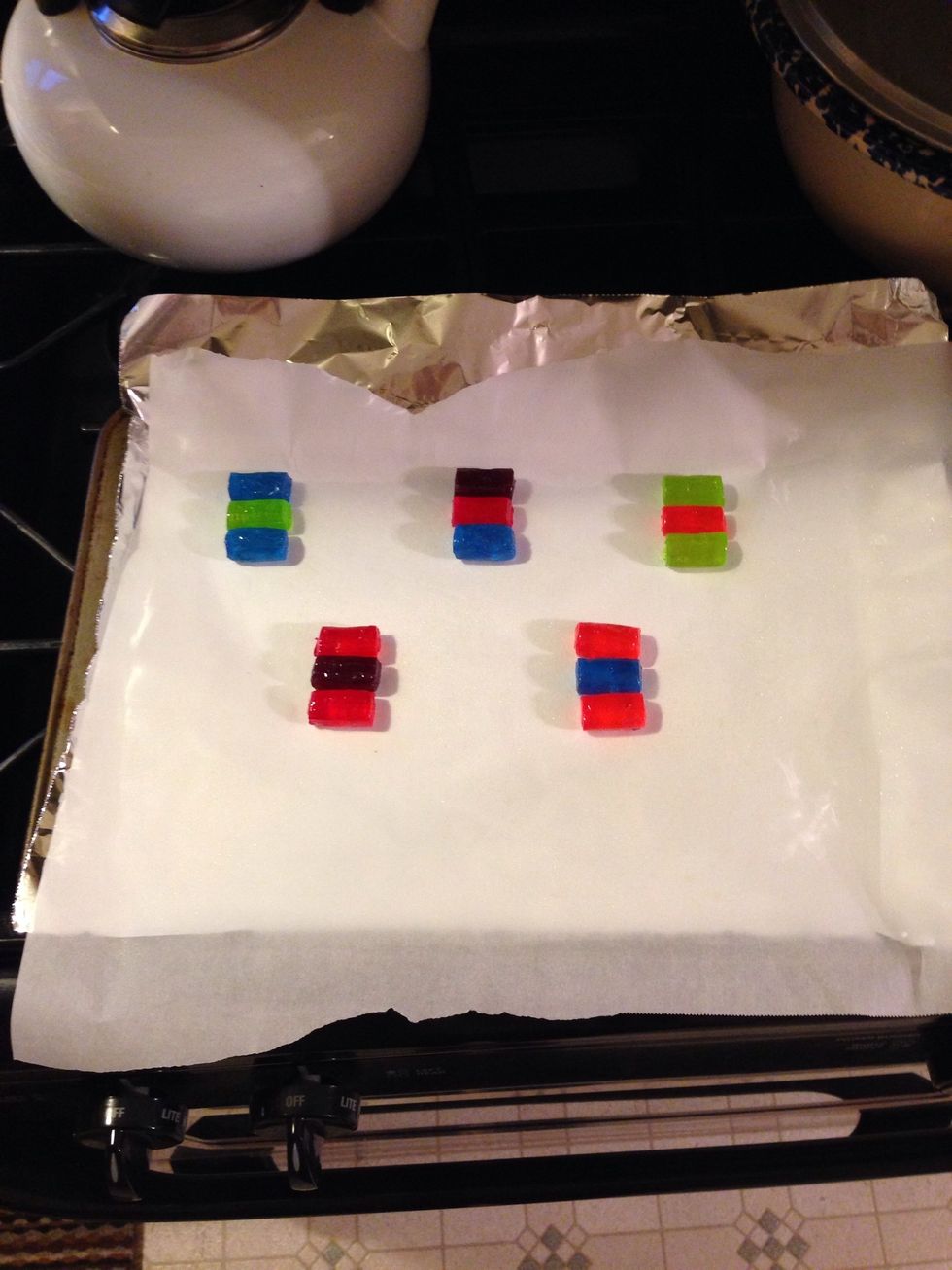 Place the jolly ranchers in threes so that they are each touching eachother