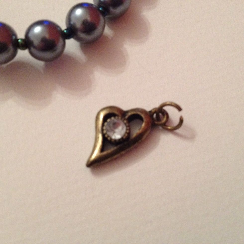 Place the jump ring through the loop on the heart charm.