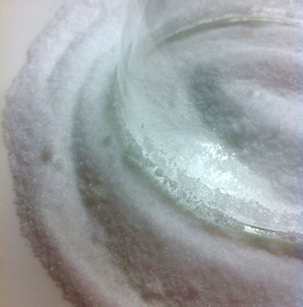 Place the lime-rubbed rim in the salt and move in a circular motion to coat it evenly.