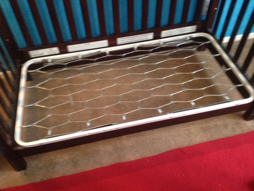 Place the mattress shelf on frame with the metal arms pointing down.