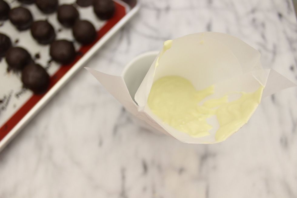 Place the melted white chocolate into a prepared paper parchment cone or a plastic sandwich bag.