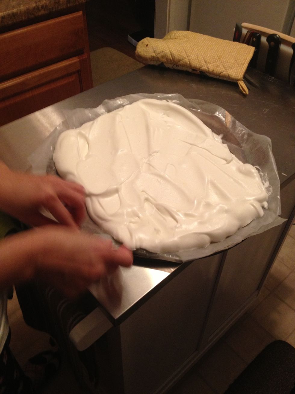 Place the meringue on top of the greased wax paper and spread evenly using a spatula.
