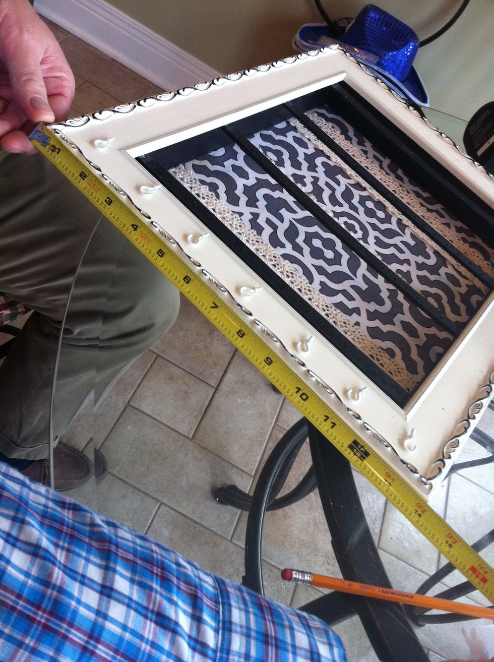 Place the mini white metal hooks about 2 inches apart for reference of where u will drill the holes for them