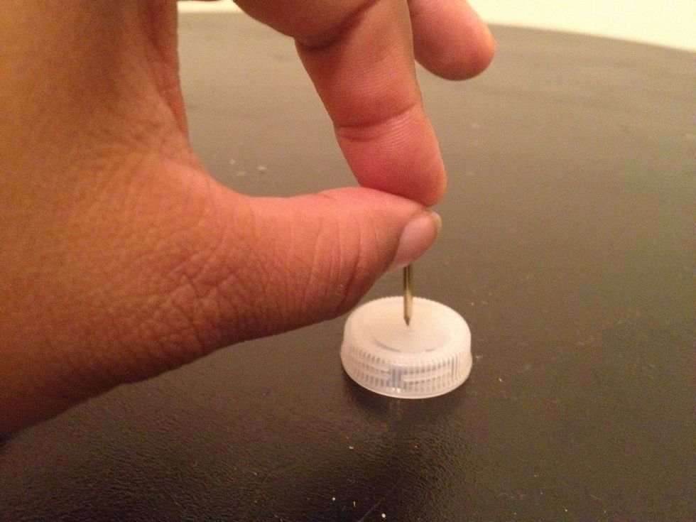Place the nail at the center of the lid