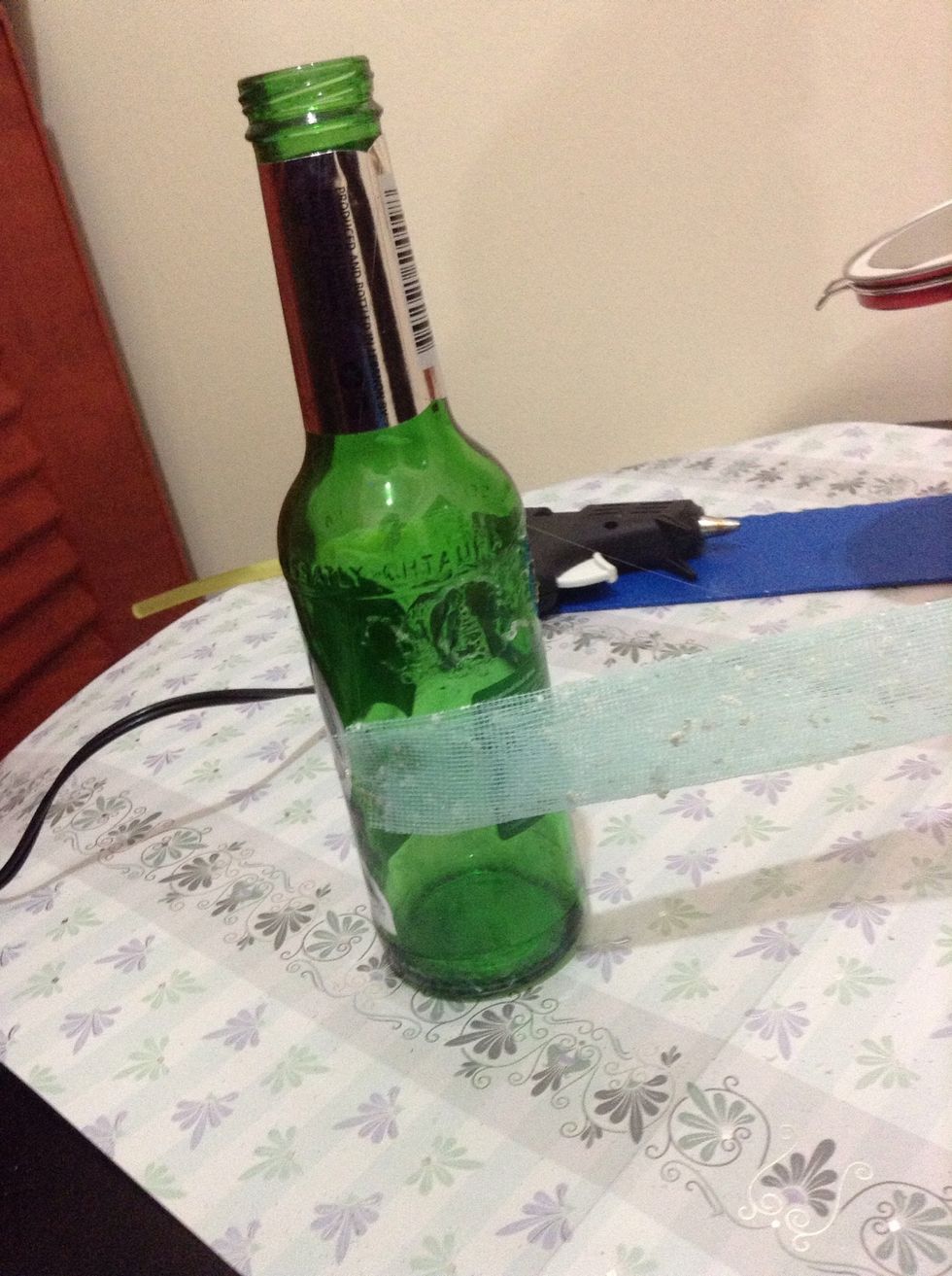 Place the net around bottle to stick the Hershey's kisses chocolate on , very easily