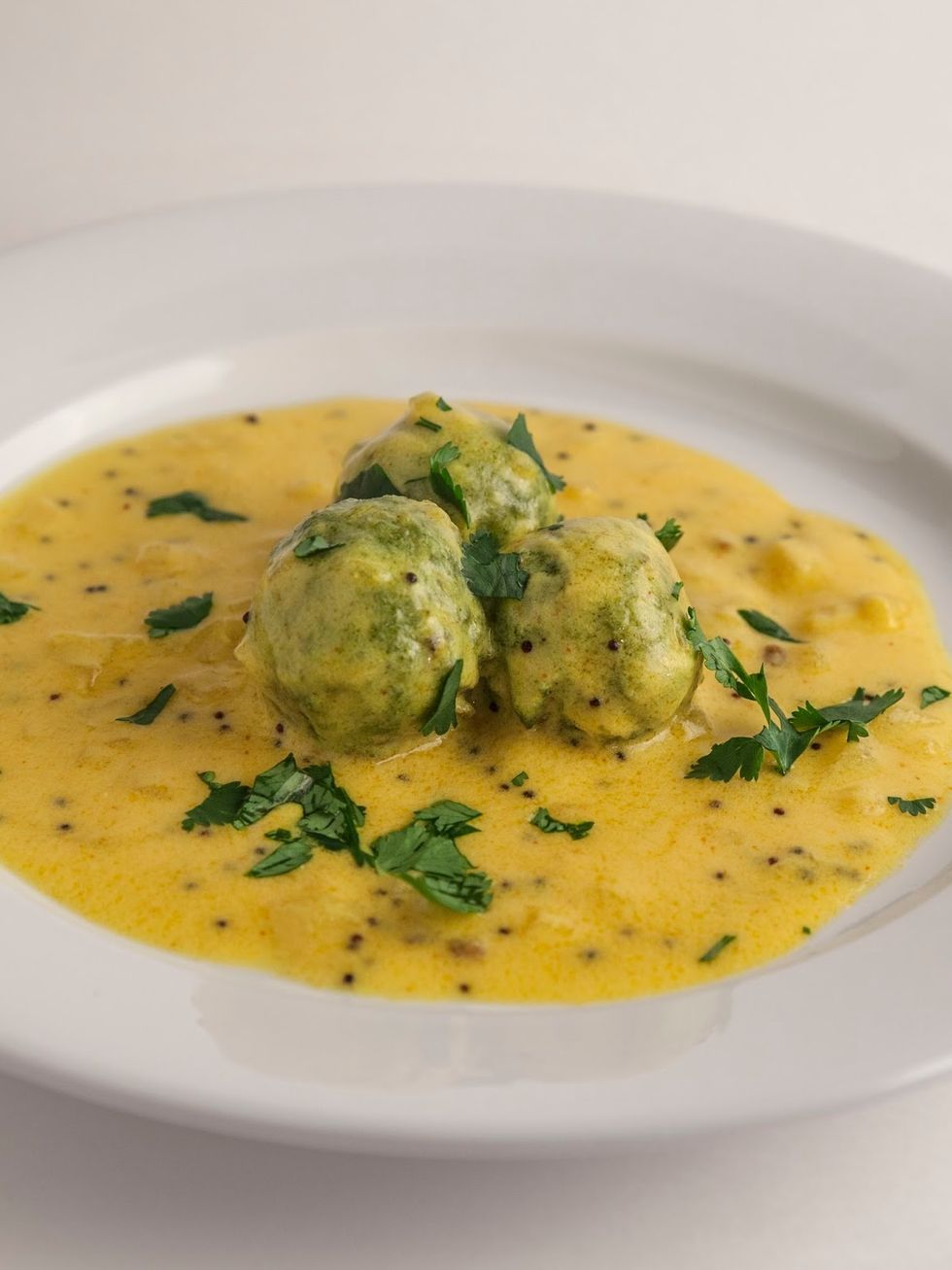 Place the nettle or spinach balls into the warm yogurt mixture. Warm the koftas in the yogurt sauce  when they're heated through, sprinkle them with a bit of chopped fresh cilantro and serve them up.