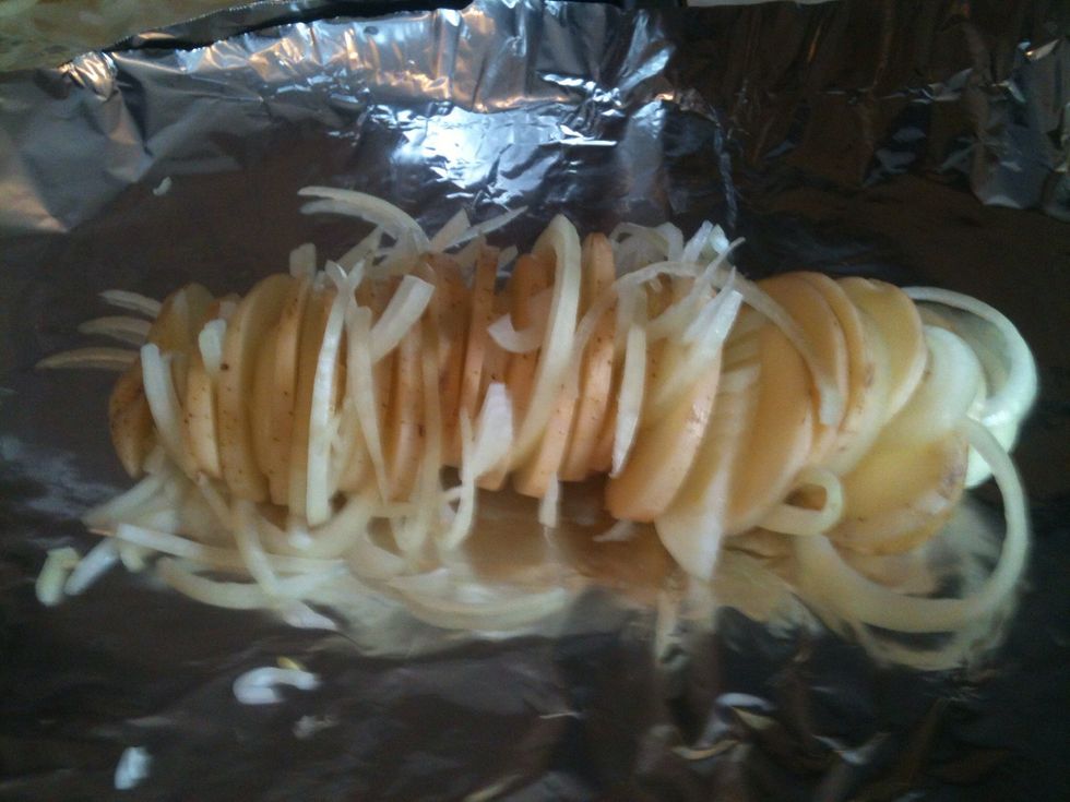 Place the onions in between the potatoes slices.