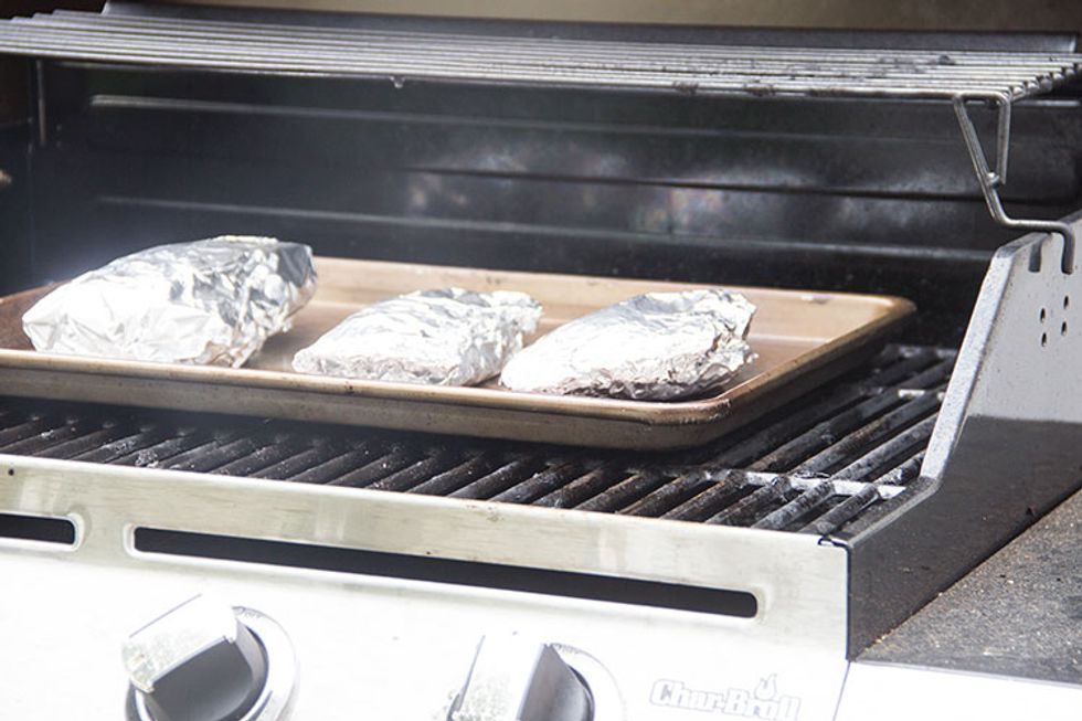 Place the packets on a baking sheet on a grill prepared for medium heat. The packets should cook for about 10 minutes one each side (first right-side-up, with the fish on top, and then flip).