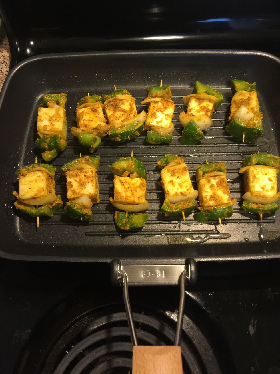 Place the paneer tikkas and cook on medium heat.