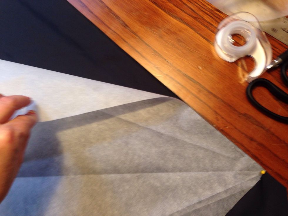 Place the pattern on the black fabric.