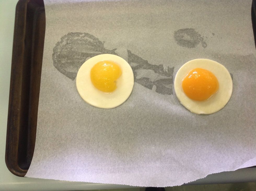 Place the peach halves, round side up, onto a square/circle of puff pastry. Leave approximately 1cm of a border around the fruit.