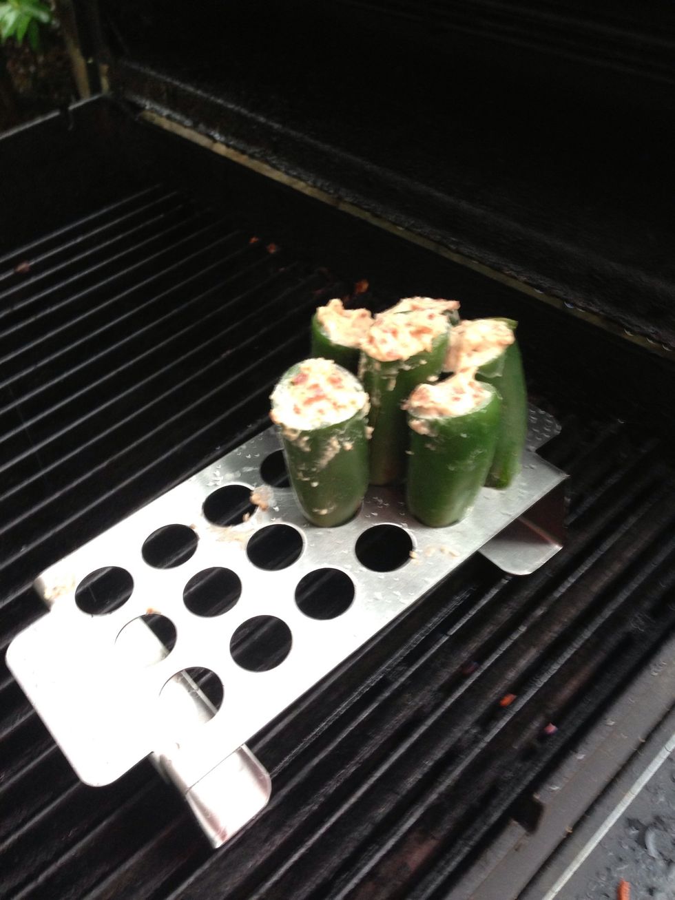 Place the peppers into the rack and then put them on the grill. As you can see from this picture my peppers were just a little bit too large and hard to stand up in the rack