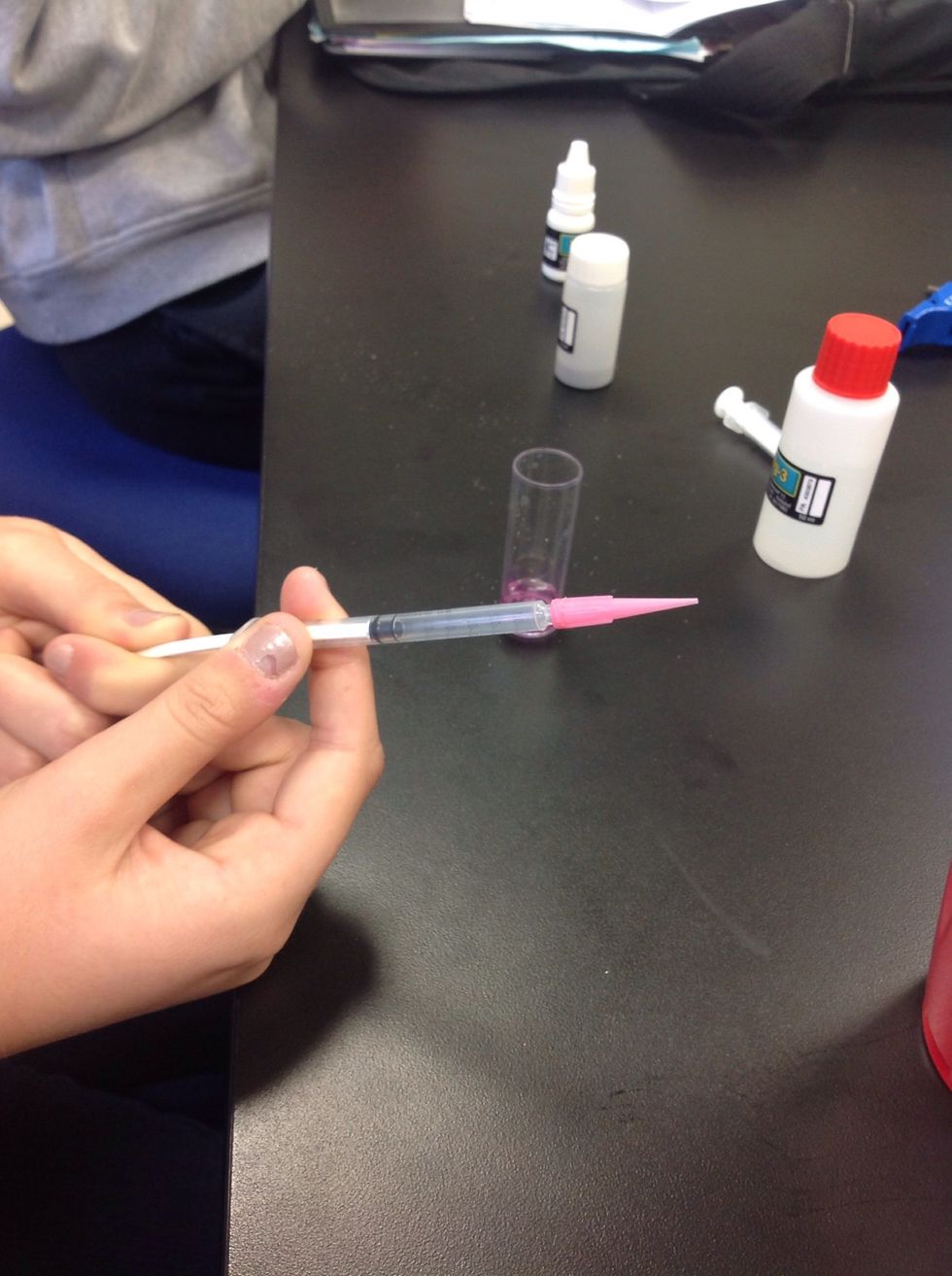 Place the pink tip firmly on the smaller syringe.
