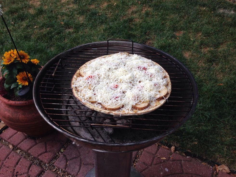 Place the pizza on the grill and cook 20 minutes or more until cheese is melted and potatoes are softened. Also, check the bottom of crust for doneness.