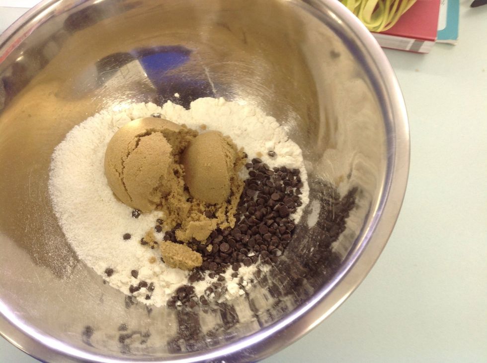 Place the plain flour, self raising flour, brown sugar, chocolate chips and coconut into a bowl