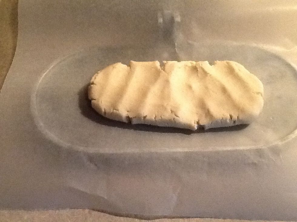 Place the plastic on the bottom and place the dough on it spreading it out like this