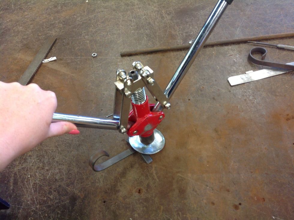 Place the pop rivet gun over the pop rivet and open and close twice, when you hear or feel a click, pull up and it should be done, and everything is held firmly together....