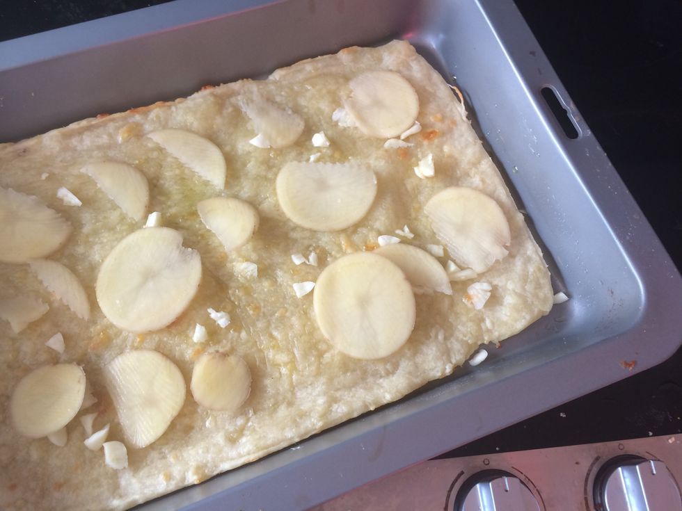 Place the potatoes over the pizza evenly.