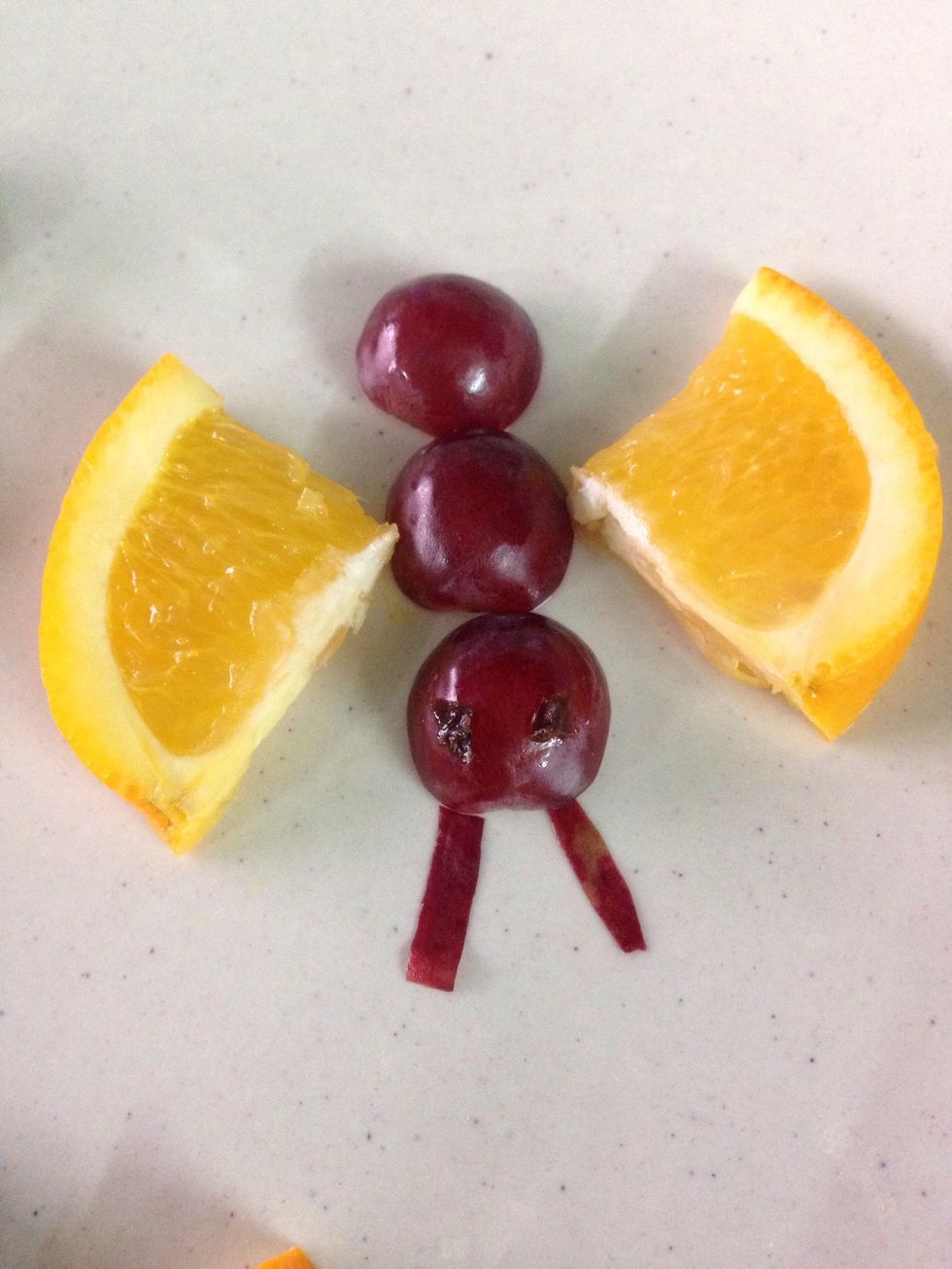 Place the raisin on the grape (the eyes).