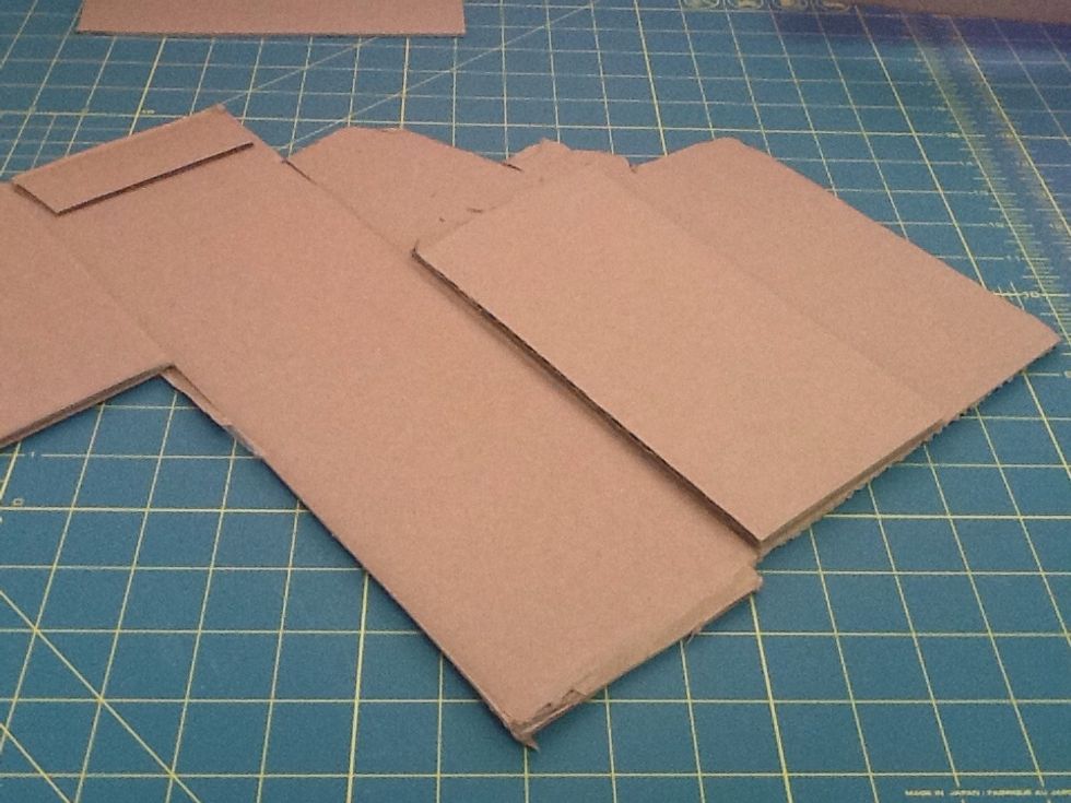 Place the rectangle side flat on your larger cardboard. This piece will be a template. Use a pencil to trace your cut line. Cut out the other three rectangles.