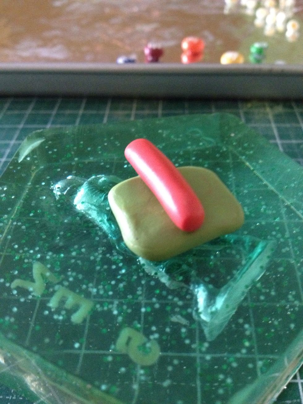 Place the red clay onto the olive one.