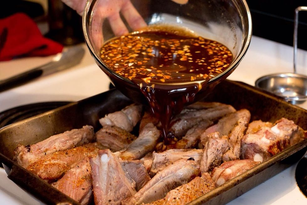 Place the ribs into a shallow pan and add the sauce.