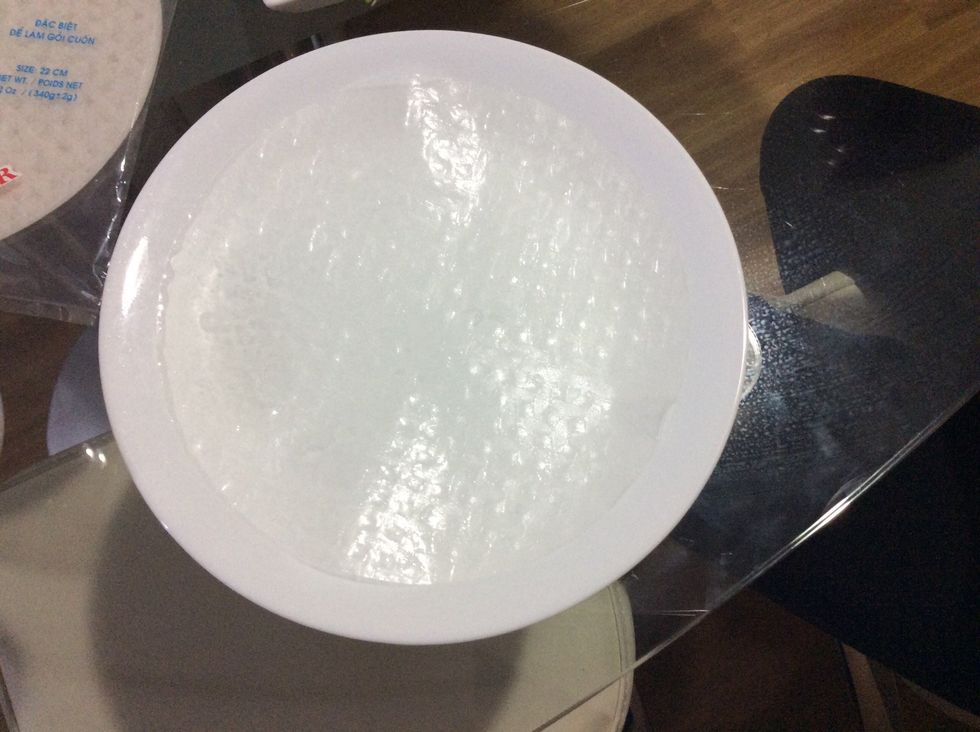Place the rice paper on a big plate so you can place the things you want in your roll.