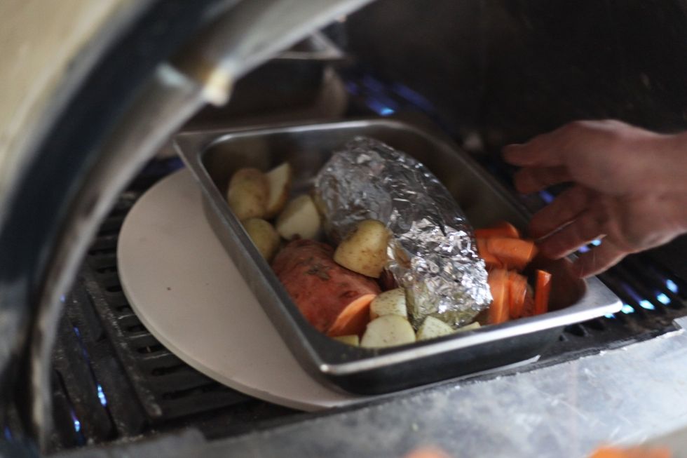 Place the roast and vegetables in the oven for 40 minutes on 200 degrees. As we're excited about our home made wood fired BBQ oven we thought we'd try it out again. In it goes...