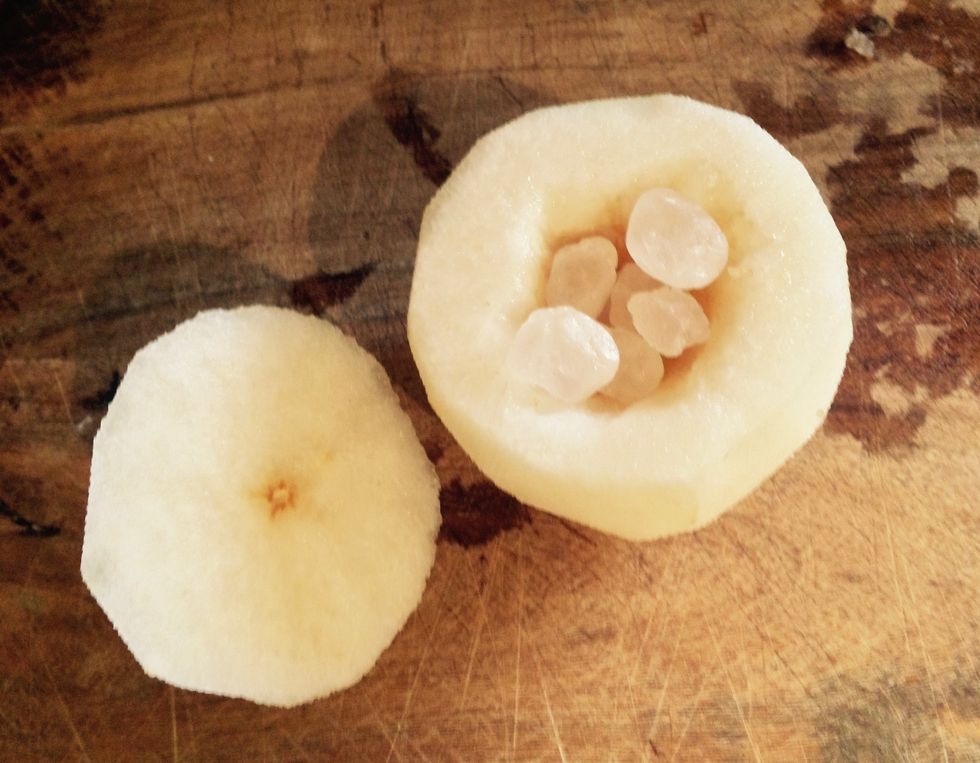 Place the rock sugar into the hallow of the pear.