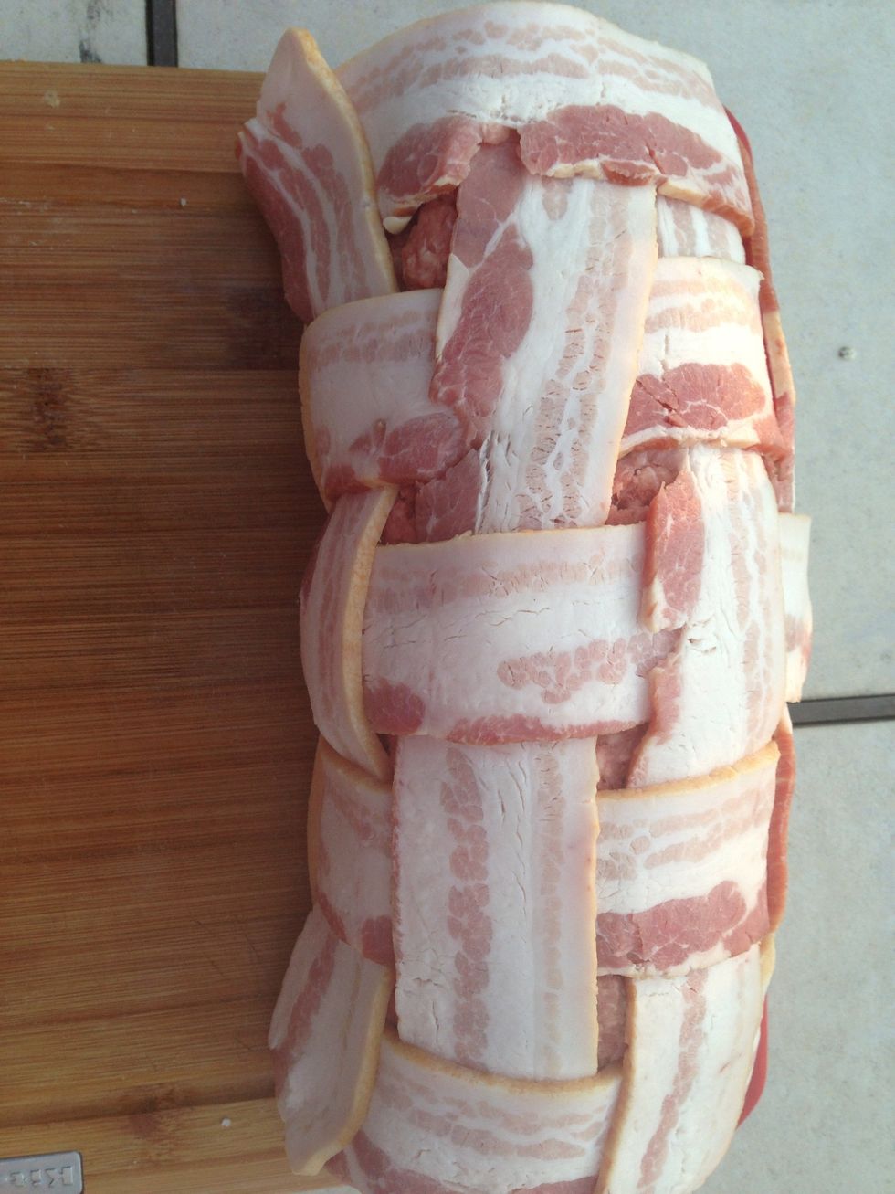 Place the roll of ground chuck in the bacon and roll it up.