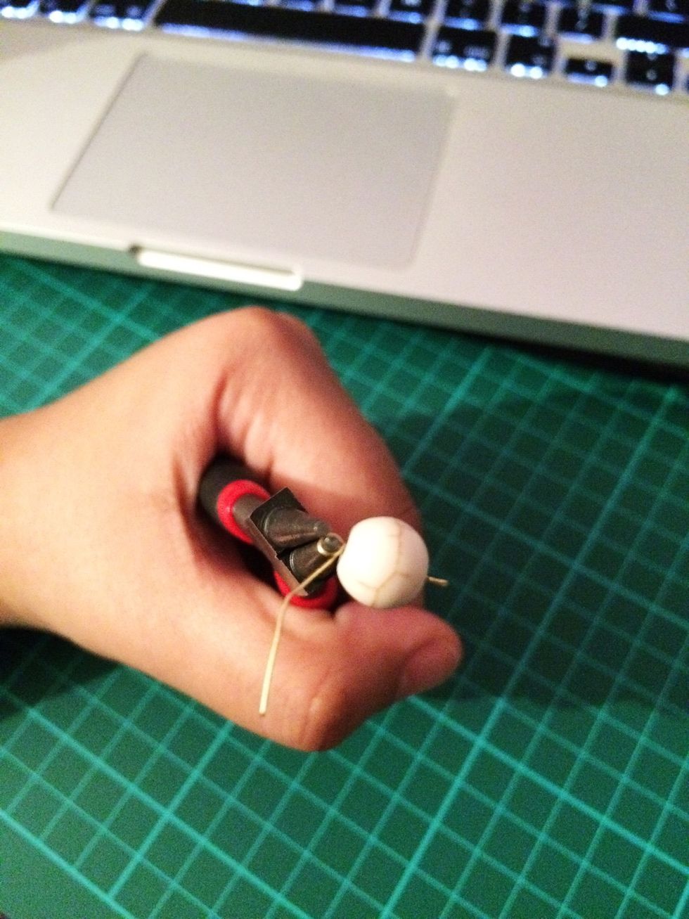 Place the round nose pliers as close to the bead as you can and wrap the wire the same as the first side as many time as possible. Cut any excess wire.