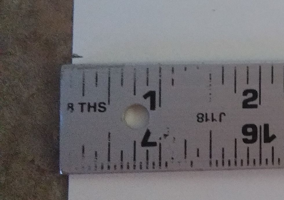 Place the ruler 2 inches up from the bottom across the page. Make a mark on the left side.