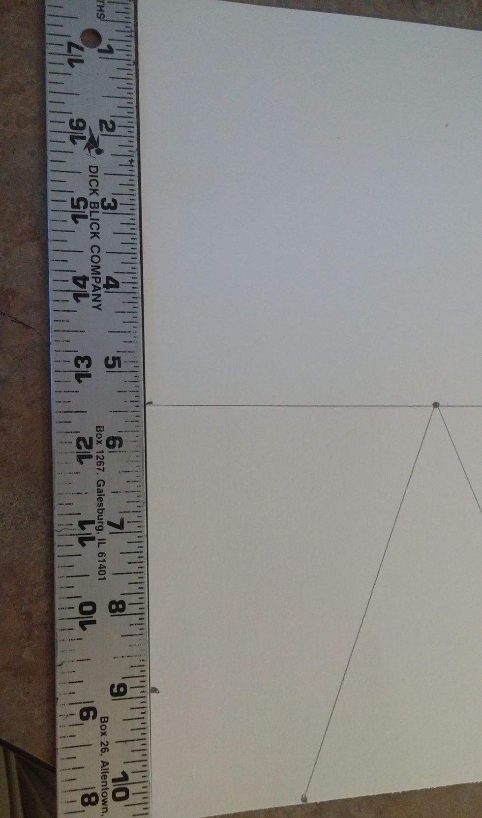 Place the ruler on the left side of the paper. make a mark at 9 inches. Do the same to the very right side of the paper as well.