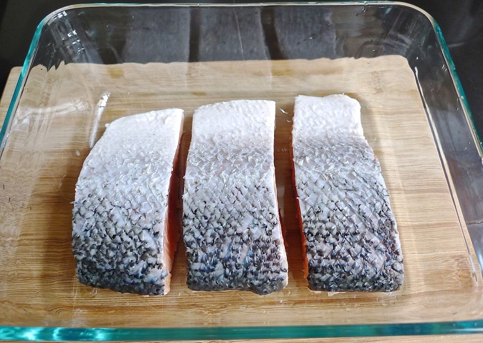 Place the salmon fillets SKIN-SIDE up in a shallow glass or plastic dish.