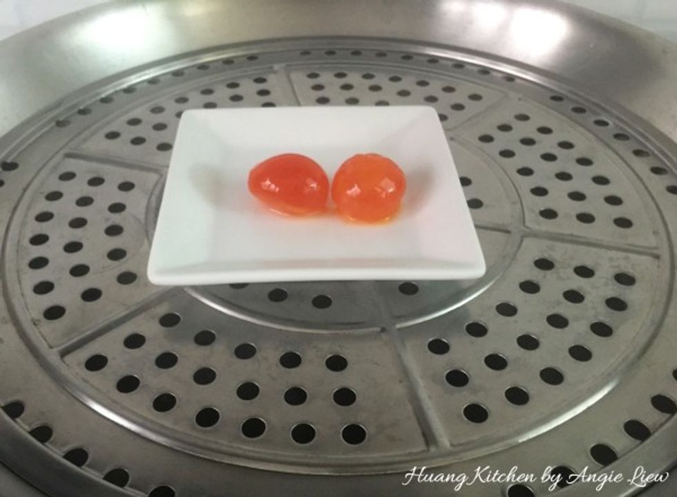 Place the salted duck egg yolks in a steamer.