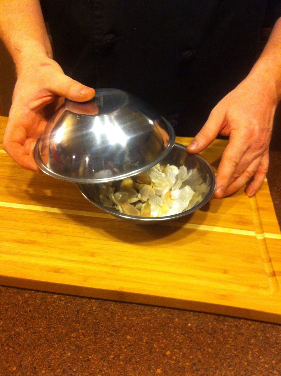 Place the second bowl on top, and line the edges up so the fit together. Grasp the bowls tightly, ensuring they'll stay together for the next step.