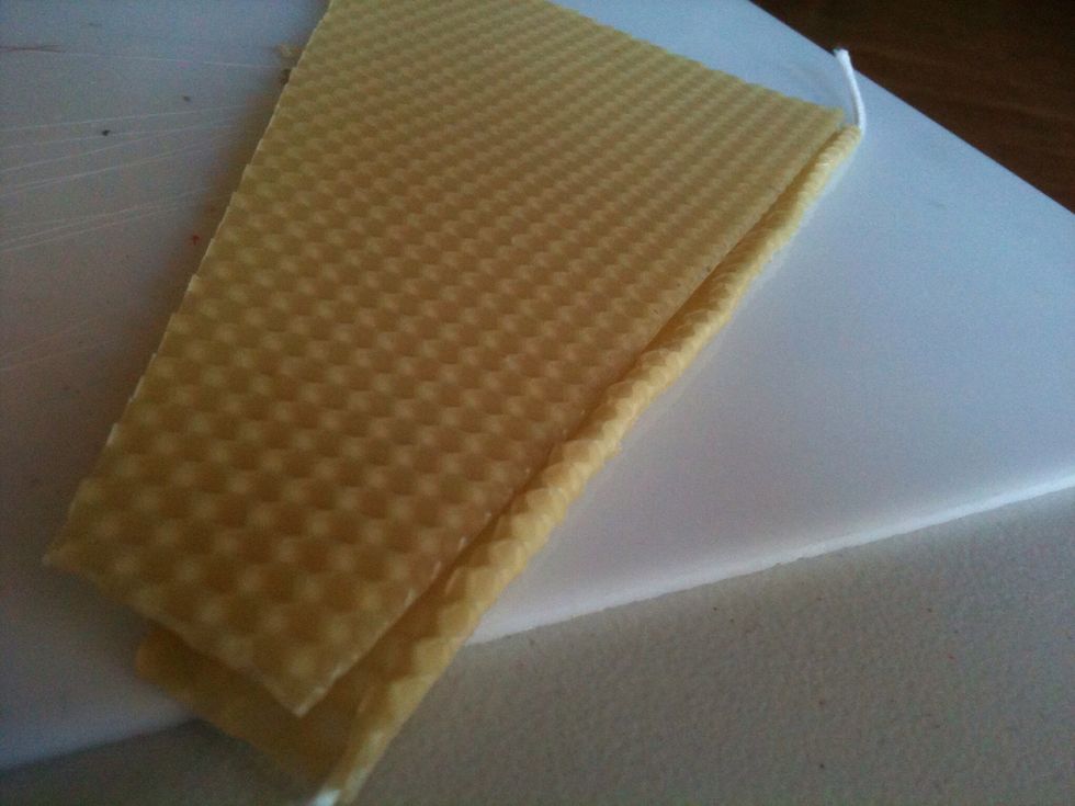 Place the second sheet of wax on top of the first sheet, making sure that both side edges are aligned, and that the bottom edge of the top piece aligns across the top edge of the first roll.